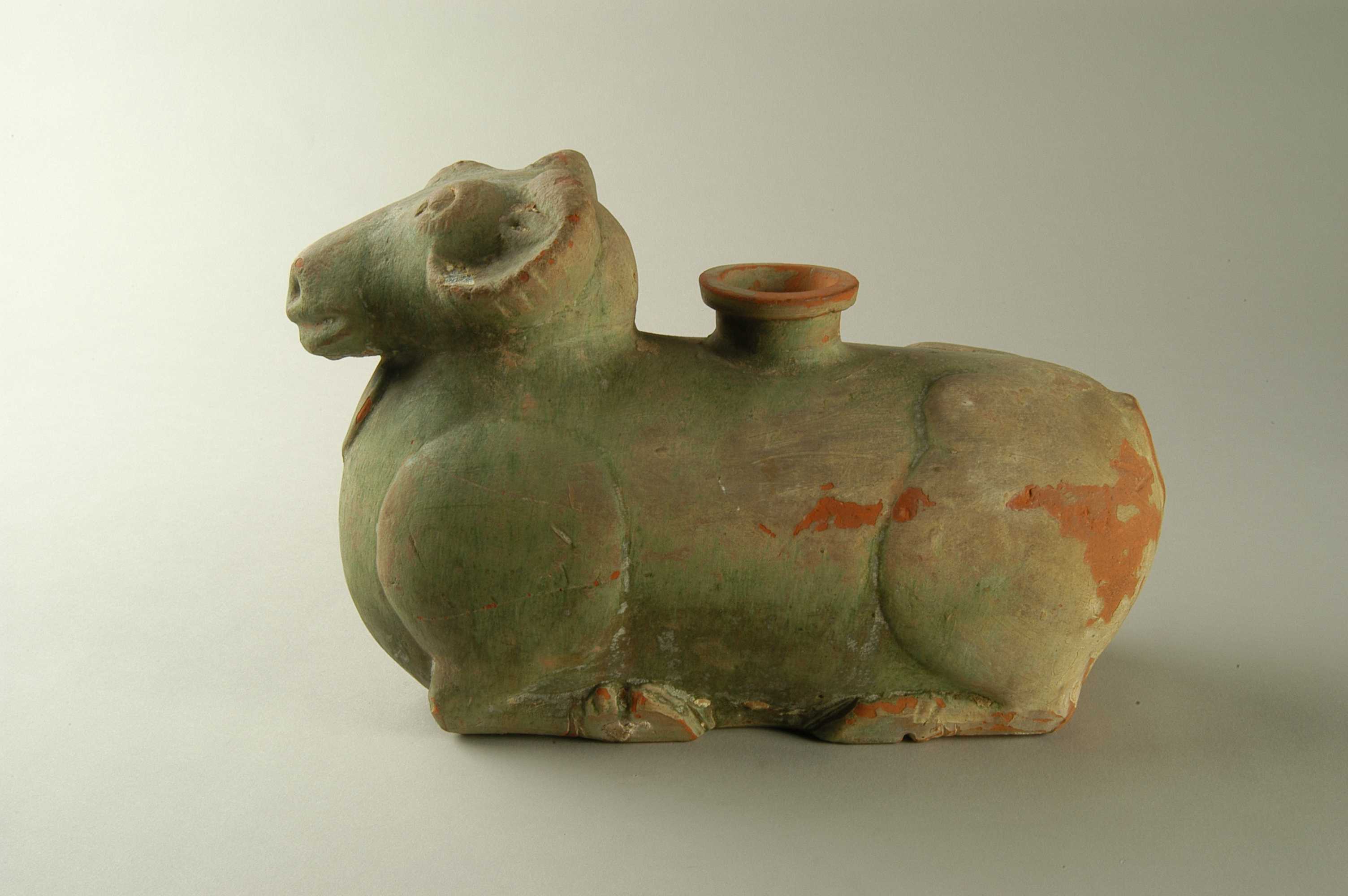 此展品为汉代的陶器,陶仓外观呈卧羊状,羊首略仰,面向前方,羊仓胎