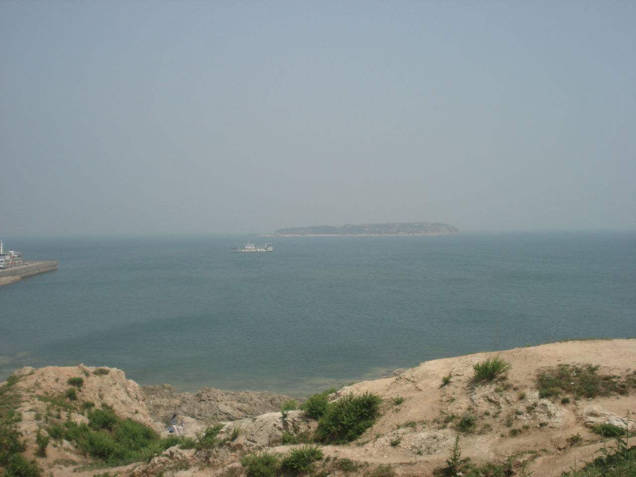 >兴城海滨 /a>向东南方向海面望去,海天交接处隐约可见一座起伏的山峦