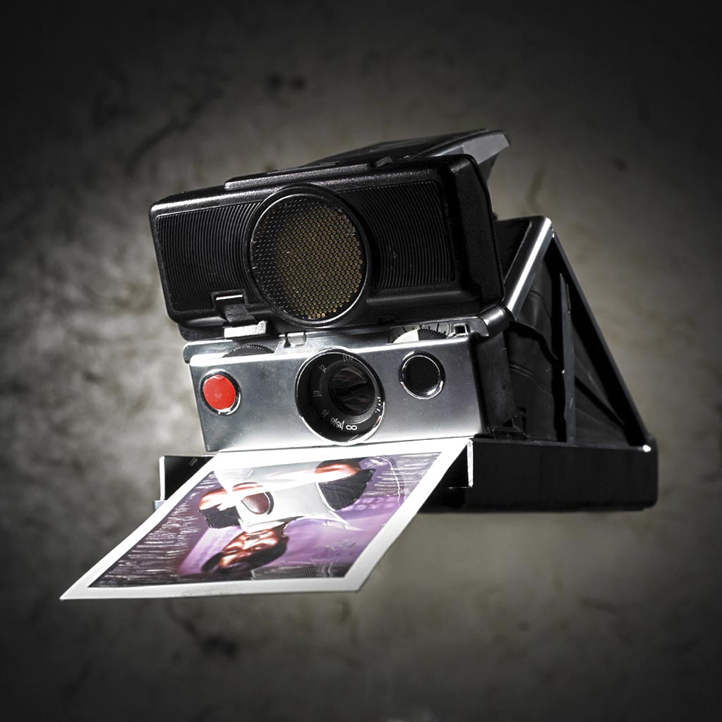 而是滑到相机背面储片匣内,可通过透明窗口即