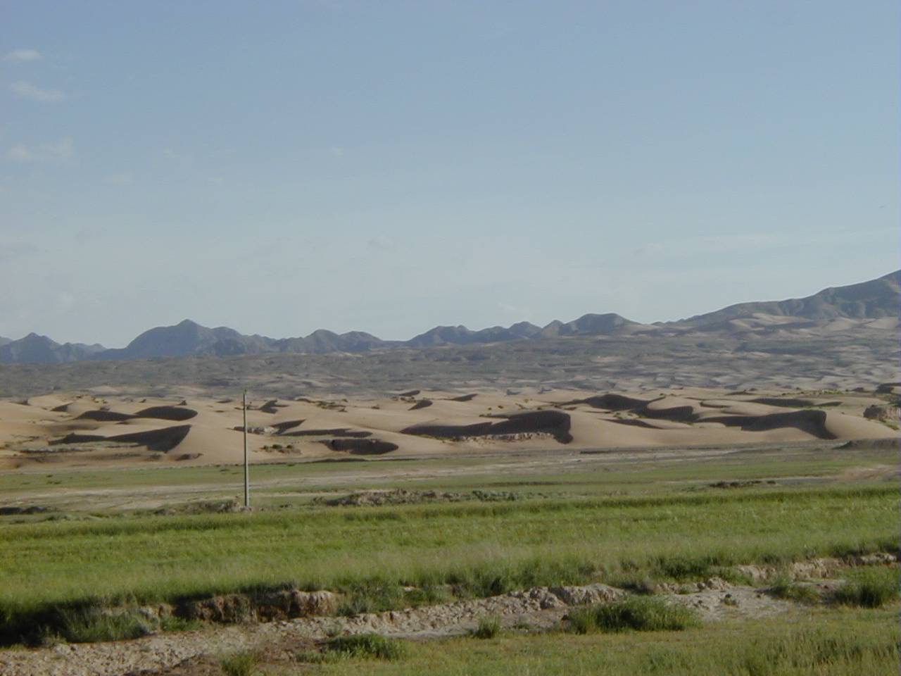  p>纵向沙垄,由风沙堆积的轴向与主要风向相平行的长条形垅状堆积地貌